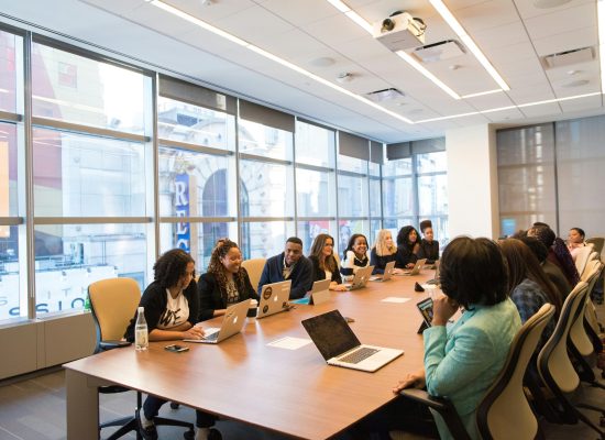 A diverse team of business professionals collaborating in a modern meeting room.